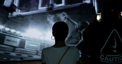 Person looking at large video projection